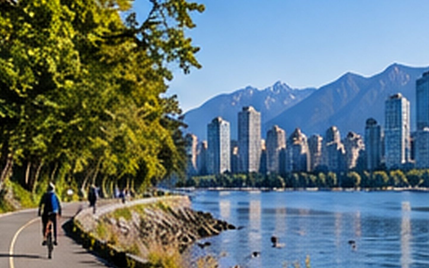 Stanley Park seawall with Vancouver skyline and mountains
